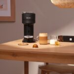 Кофемашина и кофе на деревянном столе.