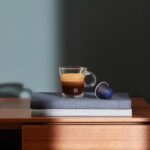 Чашка кофе с капсулой на книге