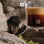 Капсула и чашка кофе на камне